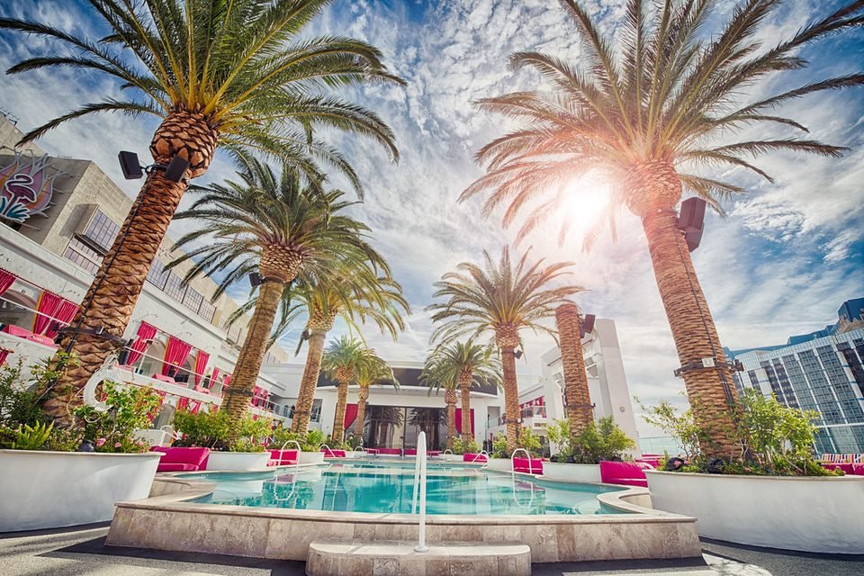Resort hotel with pool and palm trees